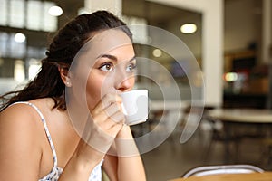 Woman sipping coffee in a bar