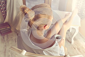 Woman sipping coffee in a magic moment of quiet