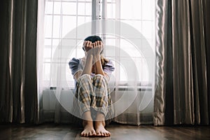 woman sit Depression Dark haired pensive glance Standing by window and anxiety Copy space