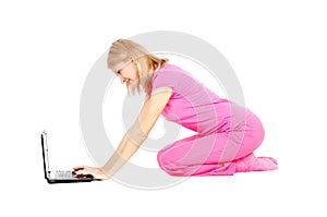 Woman sit on the floor, working on the laptop