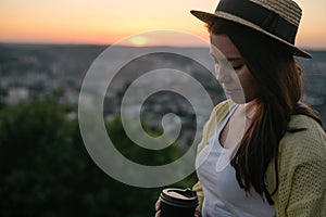 Woman sit on the hill and lookin on sunset