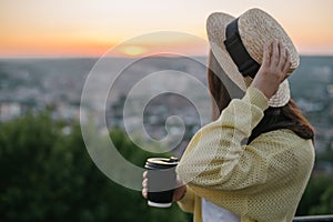 Woman sit on the hill and lookin on sunset