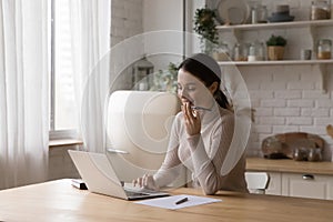 Woman sit in kitchen make business call use speakerphone