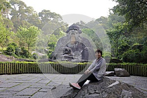 Woman sit before Laozi Statue of qingyuanshan mountain, adobe rgb photo