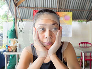 Woman sit in local restuarant in Asia.