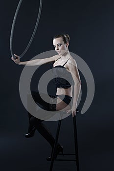 woman sit on stool with aerial hoop