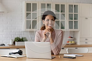 Woman sit at table with laptop take break from telework