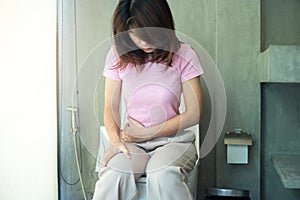 Žena sedět na záchod mísa. průjem zácpu období infekce břišní bolesti břicha, pojištění a zdravotní 