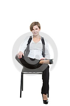 Woman sits astride a chair. legs crossed, fixed