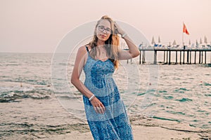 Woman sits on the beach and looks at the sea in Alanya city