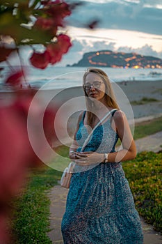 Woman sits on the beach and looks at the sea in Alanya city