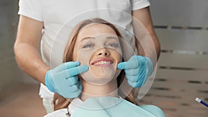A woman sits confidently in a dental chair, trusting the doctor during dental treatment, feeling comfortable and