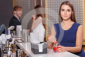 Woman sits at the counter of bar