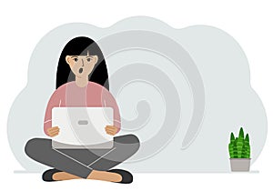 A woman sits cross-legged in his hands holding a laptop. The concept of work, education, reading, watching videos.