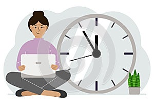 A woman sits cross-legged and holds a laptop. Next to the big clock. Time management concept, little time, much time