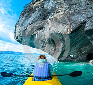 Woman paddles kayak photo