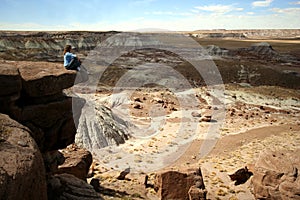 A Woman Sits on a Ledge in Petrified Forest