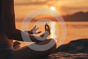 A woman sits in a lotus position in front of a body of water, focusing on her meditative posture, A person meditating as part of