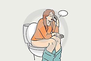 Woman sits on toilet bowl in toilet and talks on phone with friend, discussing colleagues from work