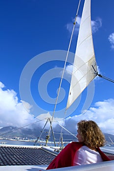 Woman sits under sail