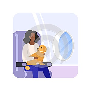 Woman sitting in airplane seat by window holding dog in arms