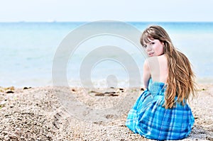 Woman sitting alone at the beach
