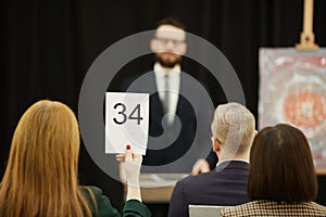 Woman sitting at auction