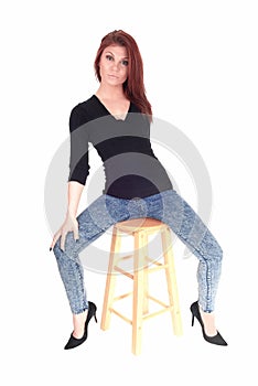 Woman sitting on bar chair.