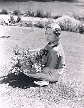 Woman sitting with basket of flowers