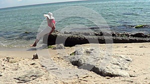 Woman sitting on the beach near sea