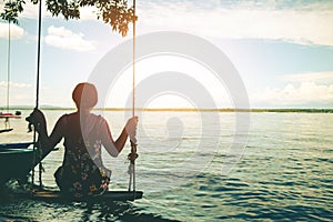 Woman sitting beach swings in beautiful.