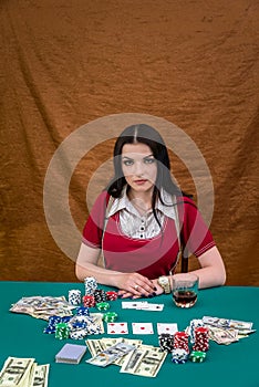 Woman sitting behind poker table in casino