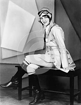 Woman sitting on a bench in a pilots uniform photo
