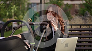 Woman sitting on bench talking on cell phone
