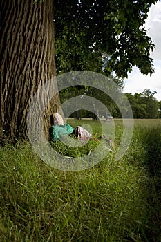 Woman Sitting Beneath Tree