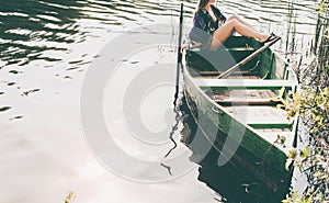 Woman sitting in boat and enjoy moments of relaxation