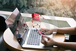 Woman sitting at cafe restaurant holding credit card with shopping online concept