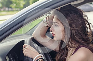 Woman sitting in car as a driver.