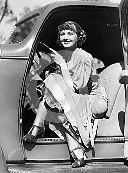 Woman sitting in a car behind the steering wheel