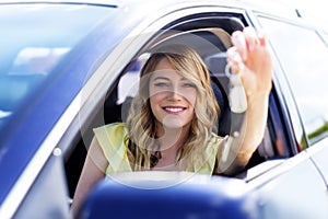 Woman sitting in the car and holding a white blank poster.