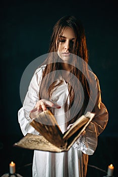 Woman sitting in the center of pentagram circle