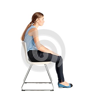 Woman sitting on chair against white background