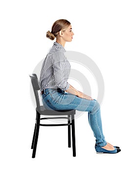 Woman sitting on chair against white background
