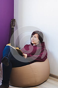 Woman sitting on a chair and compose a new song
