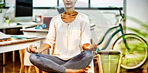 Woman sitting on chair and performing yoga