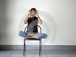 Woman sitting on chair,raise hands up and screaming.with stress and upset feeling.Have mental problems