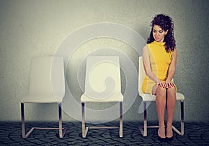 Woman sitting on a chair waiting for job interview