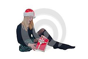 Woman sitting with Christmas hat and present in isolated background