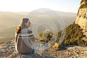 Woman sitting in a cliff contemplating views