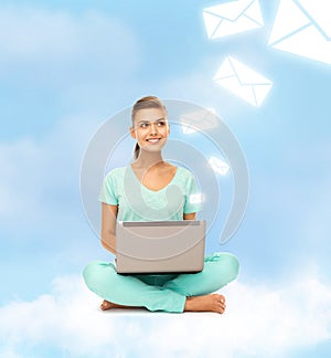 Woman sitting on the cloud with laptop